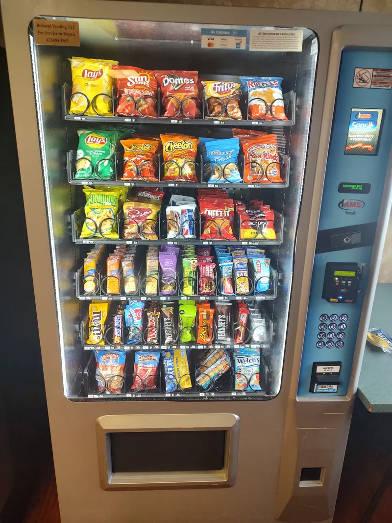 A Brainerd Vending snack machine stocked with chips, crackers, and candy